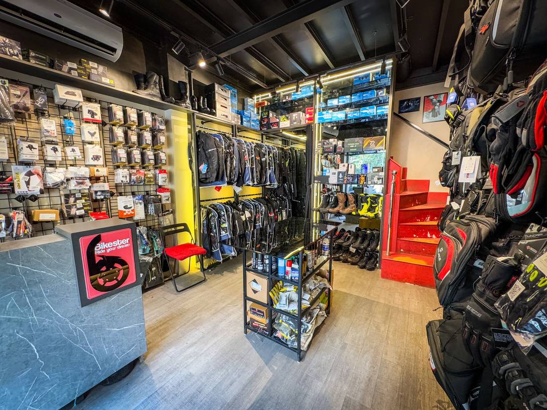 Inside Bikester Global Malad — sales counter, riding jackets and boots on display
