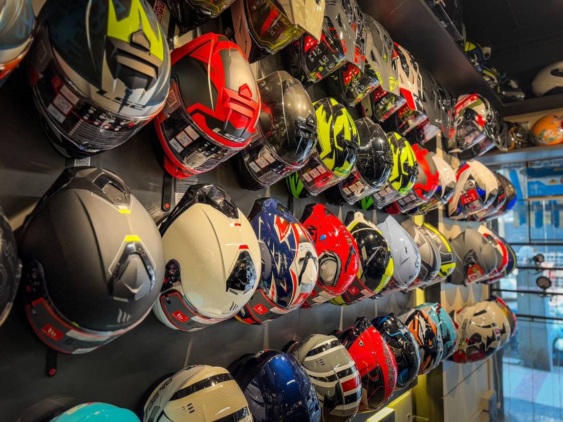 Full-face helmet wall at a Bikester Global store